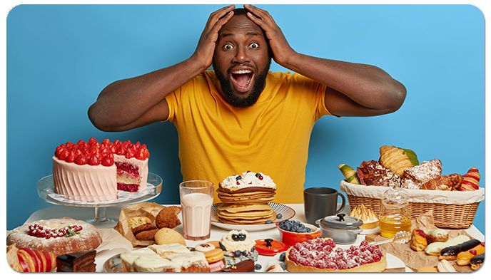 African American man surrounded by sweets and pastries